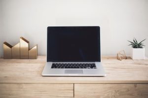 Laptop on a wooden desk.