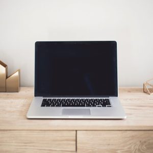 Laptop on a wooden desk.